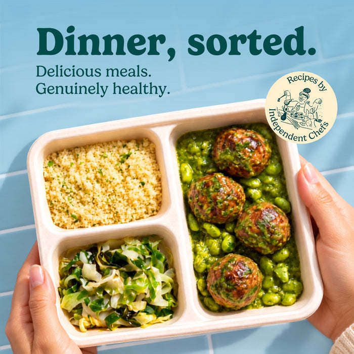 Hands holding a HomeCooks Slow-Braised Turkey Meatballs tray