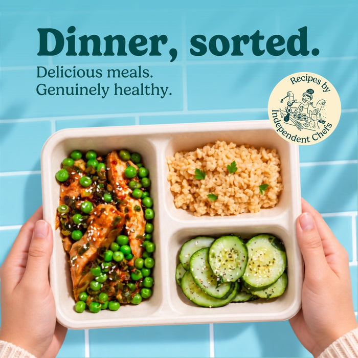 Hands holding a HomeCooks Grilled Chicken Teriyaki tray